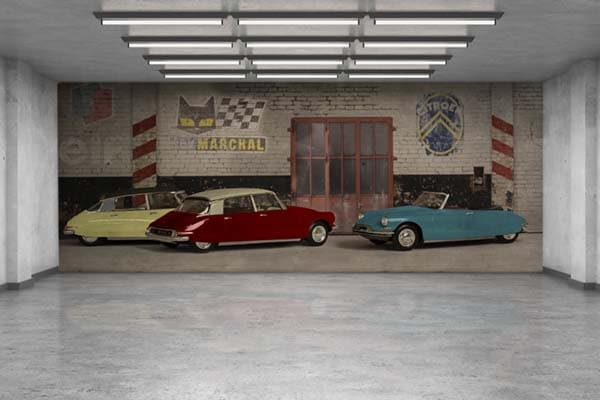 Pared decorativa para un garaje con tres Citroën DS